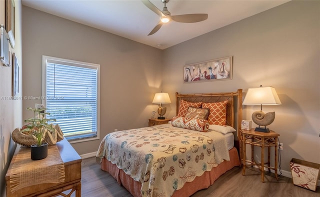 bedroom with ceiling fan and dark hardwood / wood-style floors