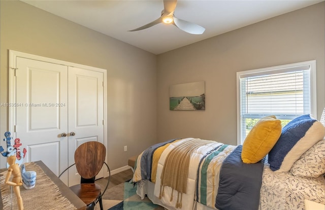 bedroom featuring dark hardwood / wood-style flooring, a closet, and ceiling fan