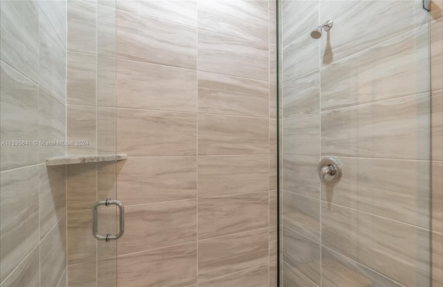 bathroom featuring a shower with door