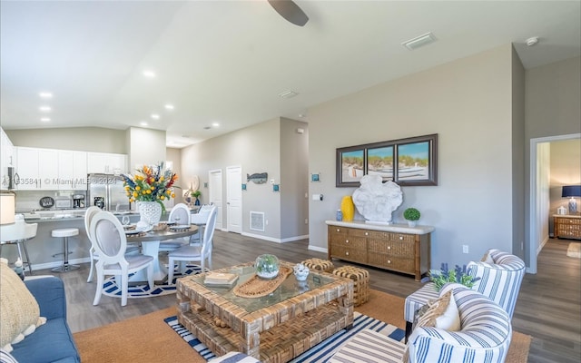 living room featuring vaulted ceiling and dark wood-type flooring