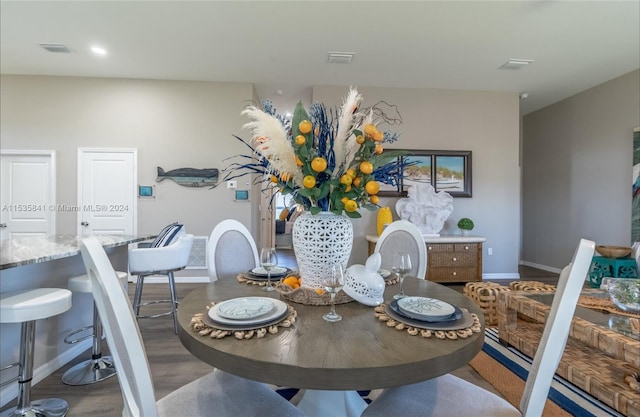 dining area featuring dark wood-type flooring