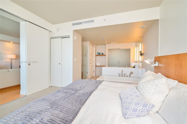 bedroom featuring a closet and light wood-type flooring