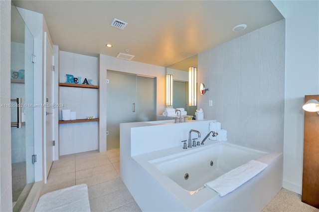 bathroom with tile floors and a bathtub