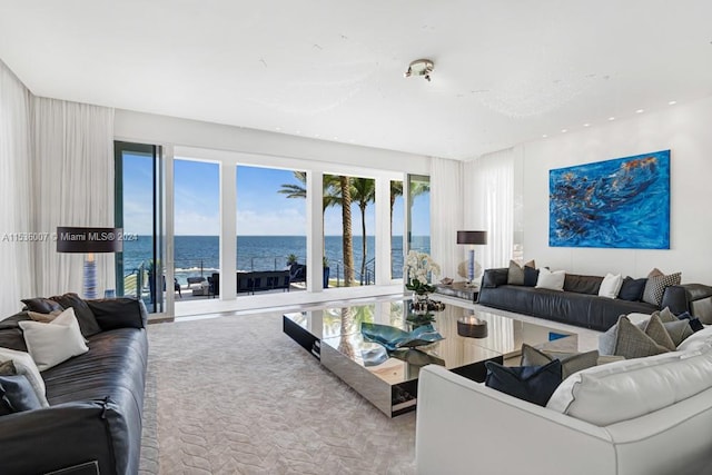 living room featuring light carpet and a water view