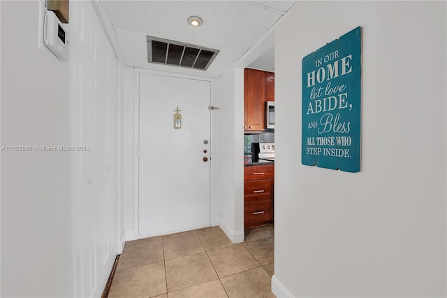 hall featuring light tile flooring