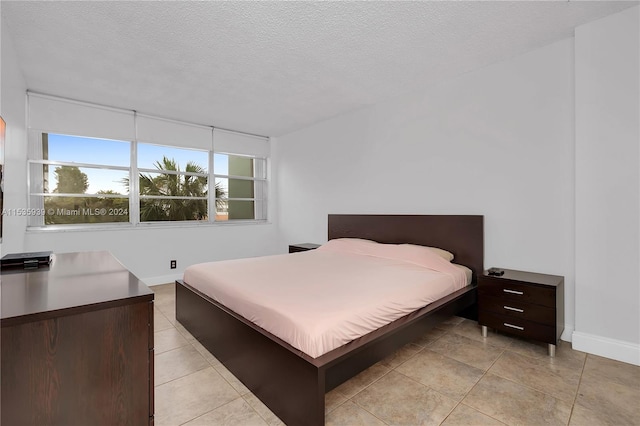 tiled bedroom with a textured ceiling