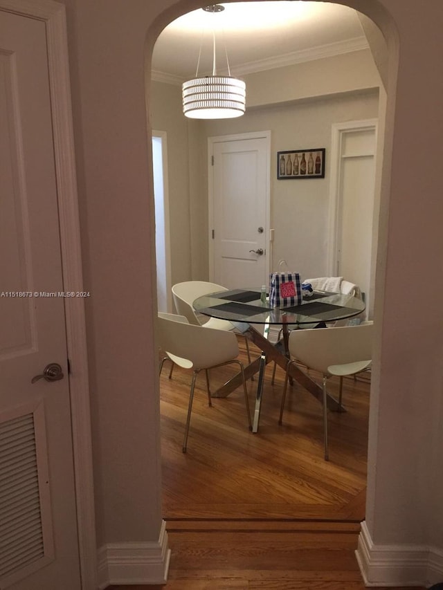 dining room featuring hardwood / wood-style floors and ornamental molding