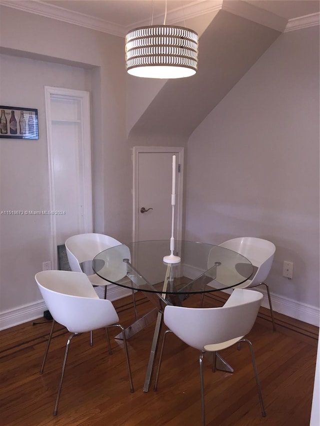 dining room with crown molding, dark wood-type flooring, and lofted ceiling