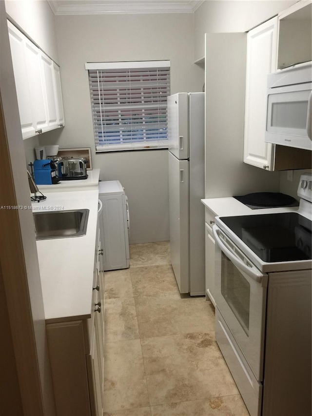 kitchen with white appliances, sink, white cabinetry, and light tile floors