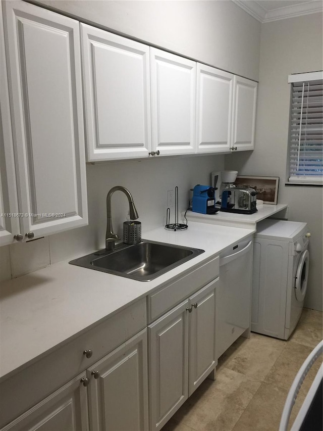 laundry room featuring light tile floors, cabinets, washer / clothes dryer, crown molding, and sink