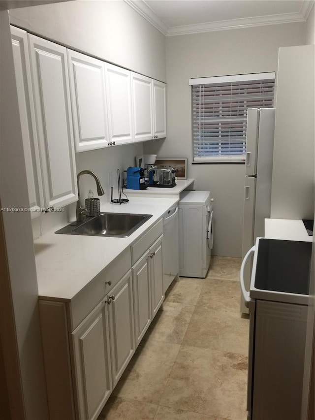 clothes washing area featuring crown molding, independent washer and dryer, sink, and light tile floors