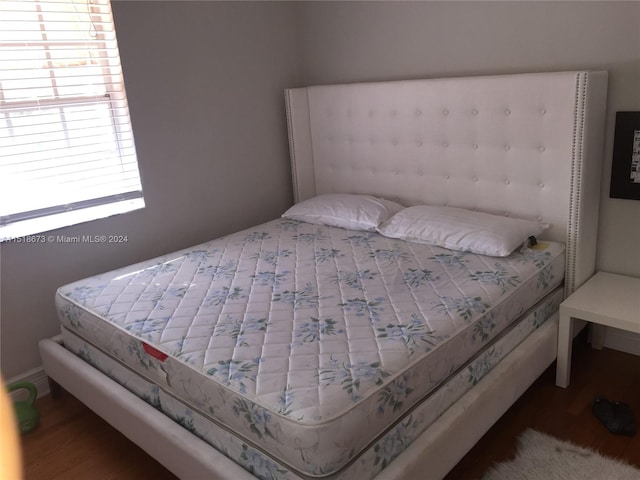 bedroom with dark hardwood / wood-style flooring