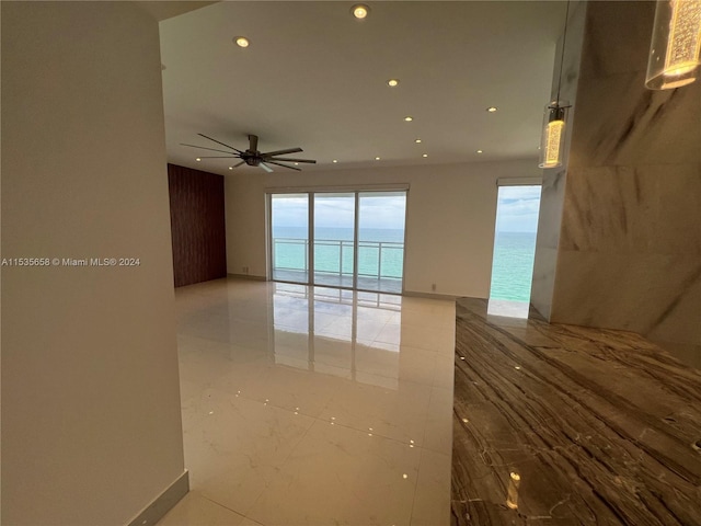 empty room with a water view and ceiling fan