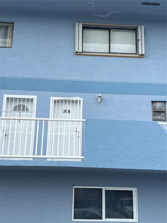 view of side of home with a balcony