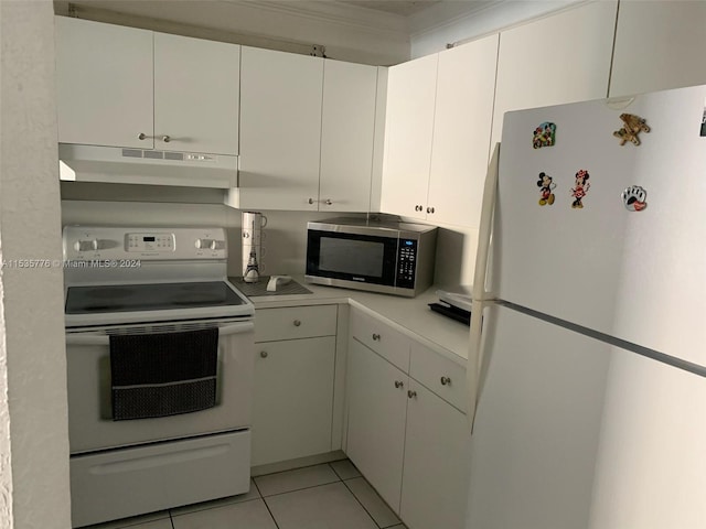 kitchen featuring range with electric cooktop, white refrigerator, white cabinetry, and light tile flooring