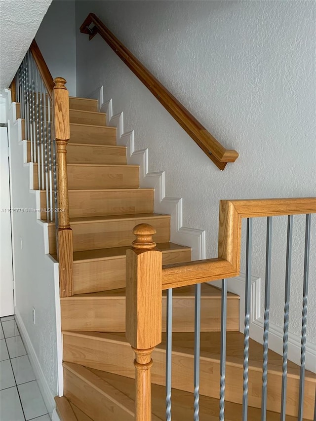 stairs featuring tile floors