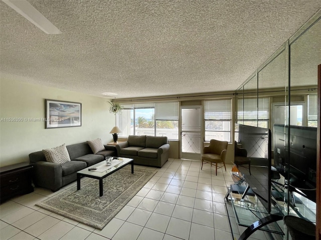 tiled living room featuring a textured ceiling