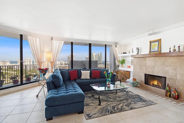 tiled living room with tile walls, a tile fireplace, floor to ceiling windows, and ornamental molding