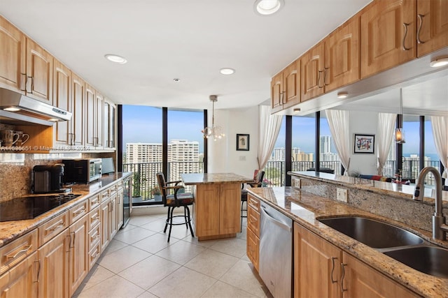 kitchen featuring expansive windows, decorative light fixtures, a chandelier, light stone counters, and dishwasher