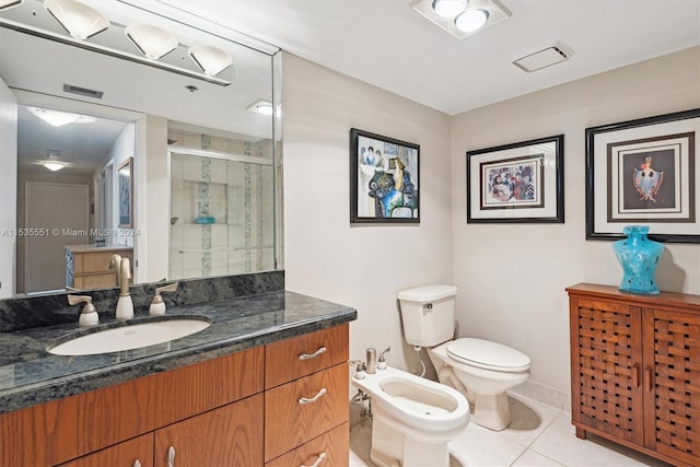 bathroom featuring a bidet, tile floors, large vanity, and toilet