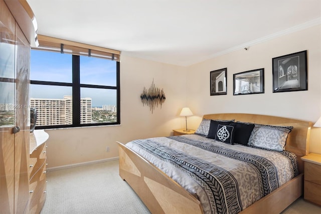 carpeted bedroom with ornamental molding