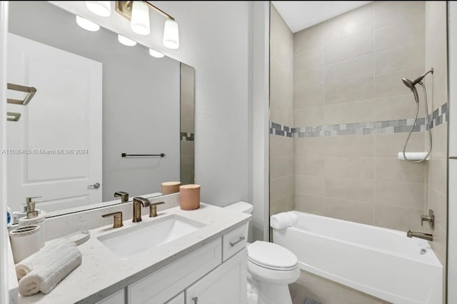 full bathroom with toilet, large vanity, and tiled shower / bath