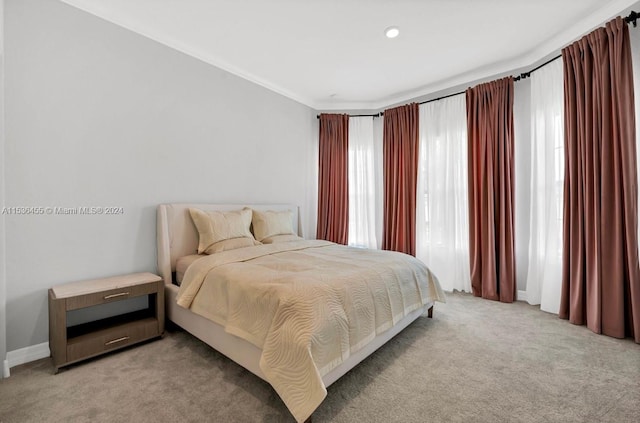 carpeted bedroom featuring ornamental molding