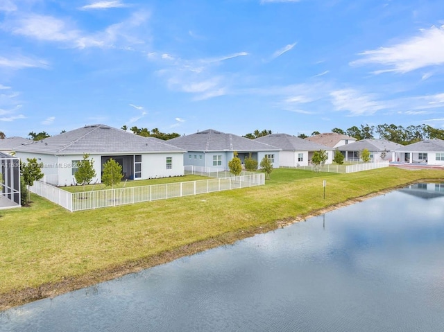 ranch-style house with a front yard and a water view