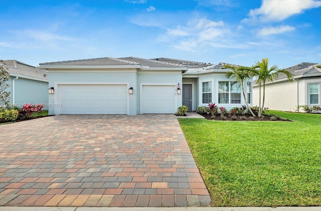 view of front of home with a front yard and a garage