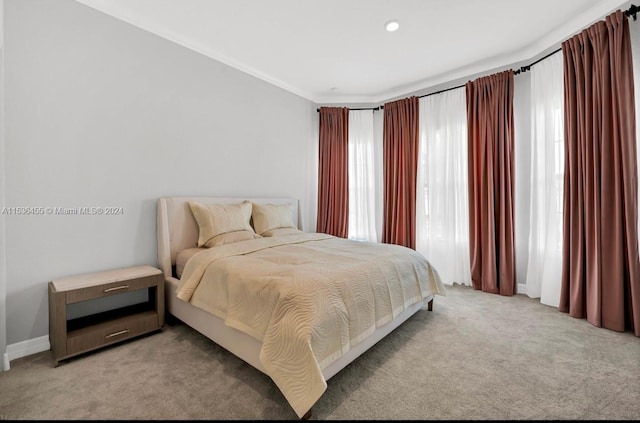 carpeted bedroom with ornamental molding