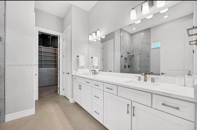 bathroom featuring a shower with shower door, dual vanity, and tile flooring