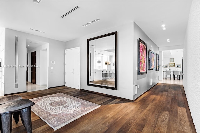 corridor with hardwood / wood-style floors