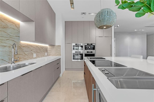 kitchen featuring sink, light tile flooring, decorative light fixtures, and double oven