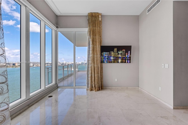 tiled spare room with a water view