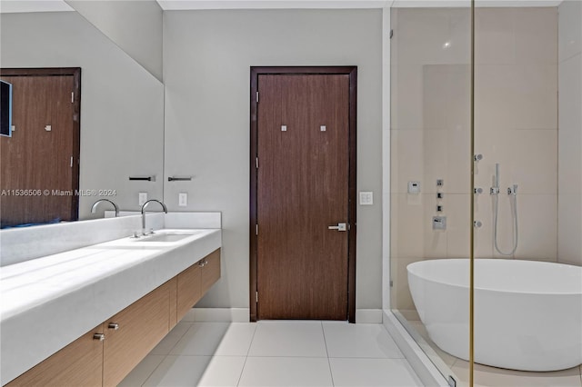 bathroom with vanity, tile floors, and a bathing tub