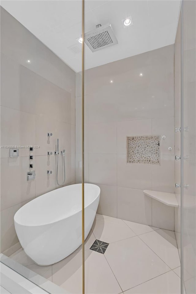 bathroom with tiled shower, tile walls, and tile floors