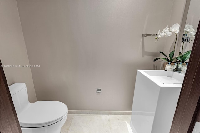 bathroom featuring tile flooring, toilet, and vanity