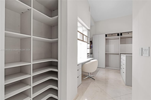 spacious closet featuring light tile floors