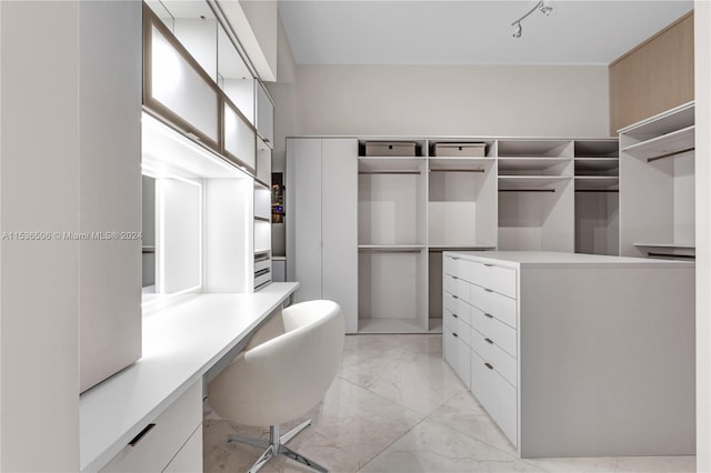 spacious closet with light tile flooring