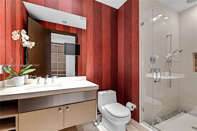 bathroom featuring a shower with shower door, vanity, toilet, and tile floors