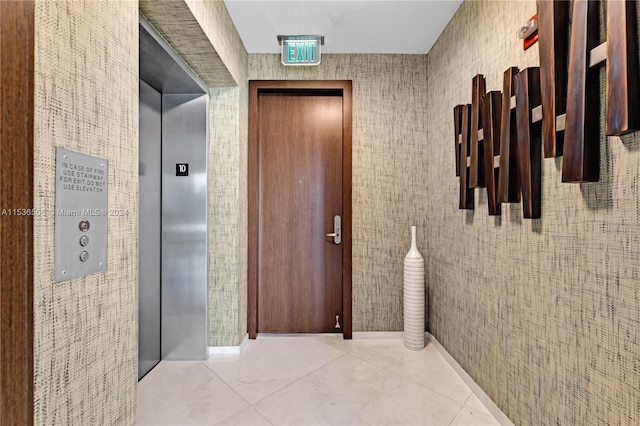 hallway featuring tile floors and elevator