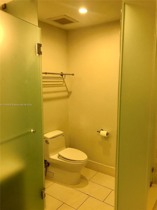 bathroom with tile flooring and toilet