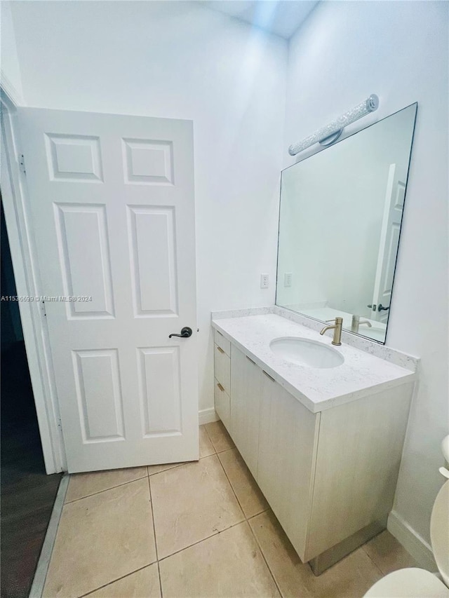 bathroom with vanity, tile flooring, and toilet