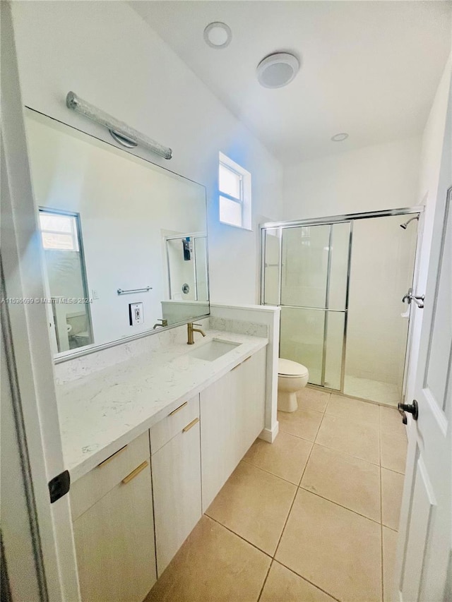 bathroom featuring toilet, tile floors, an enclosed shower, and vanity