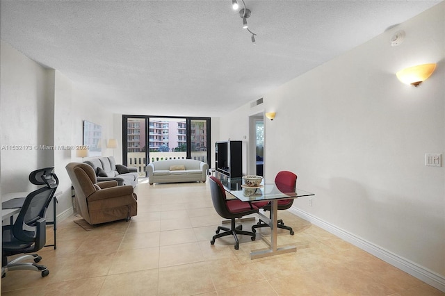 tiled office with a textured ceiling and track lighting