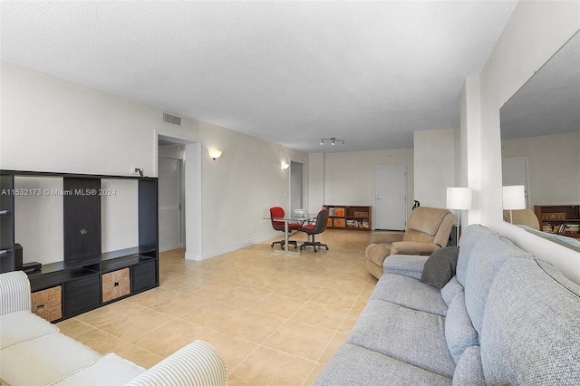 tiled living room with a textured ceiling