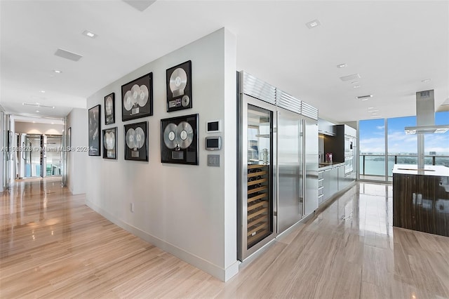 corridor featuring expansive windows and light wood-type flooring