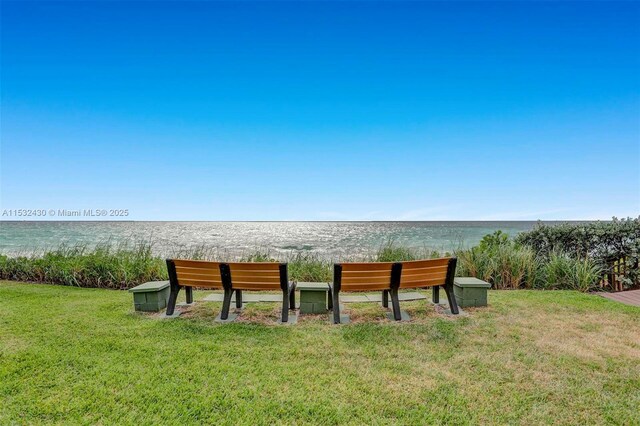 exterior space with a water view and a yard