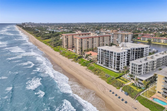 birds eye view of property with a view of the beach and a water view