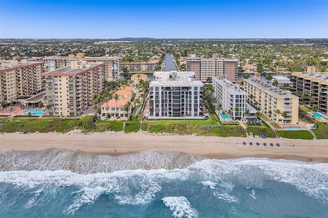 aerial view with a water view and a beach view